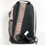Beige and black crossbody sling bag with breathable mesh back panel and adjustable strap.