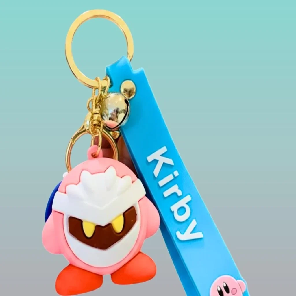 Meta Knight and Kirby silicone keychain featuring a blue strap against a light blue gradient background.